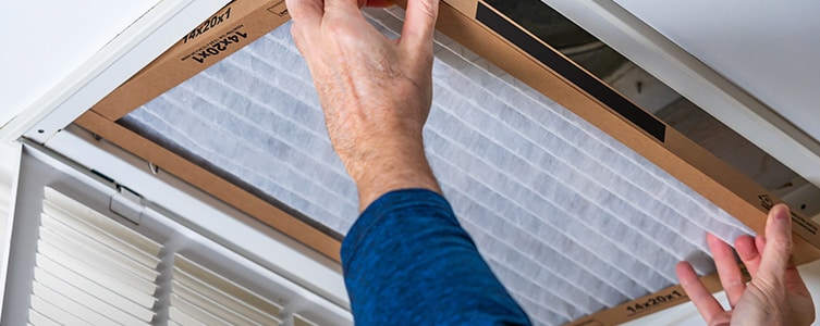 Man installing furnace filter